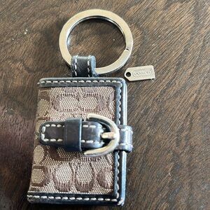 Coach picture book keychain in traditional brown.
